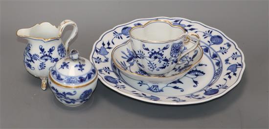 A Meissen blue onion pattern cup, saucer, cream jug, dish and sugar bowl and cover